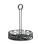 A black powder coated metal holder with ornate scrollwork, featuring a round base, open sides, and a tall center handle with a merchandising ring loop. This Mediterranean Versa Rack is empty and photographed against a white background.
