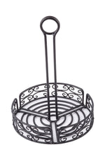 A black powder coated metal napkin holder with an ornate swirl design. It is circular with a tall handle, ending in a merchandising ring loop. The holder is empty and placed on a white background.