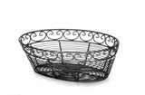 A black powder coated metal oval basket from the TableCraft Mediterranean Collection Basket line. Its open design features elegant swirling patterns along the top edge, highlighting intricate, airy metalwork against a white background.