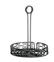 A black powder coated metal napkin holder with ornate scrollwork designs and a circular merchandising ring handle on top. This Mediterranean Versa Rack features an open side pattern and a tall central handle for easy carrying, set against a white background.