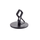 A black, powder coated metal Number/Card Holder Stand with a round base and a central geometric, wire-like structure featuring angular bends and loops. The object is photographed on a white background, with no visible logos or markings.
