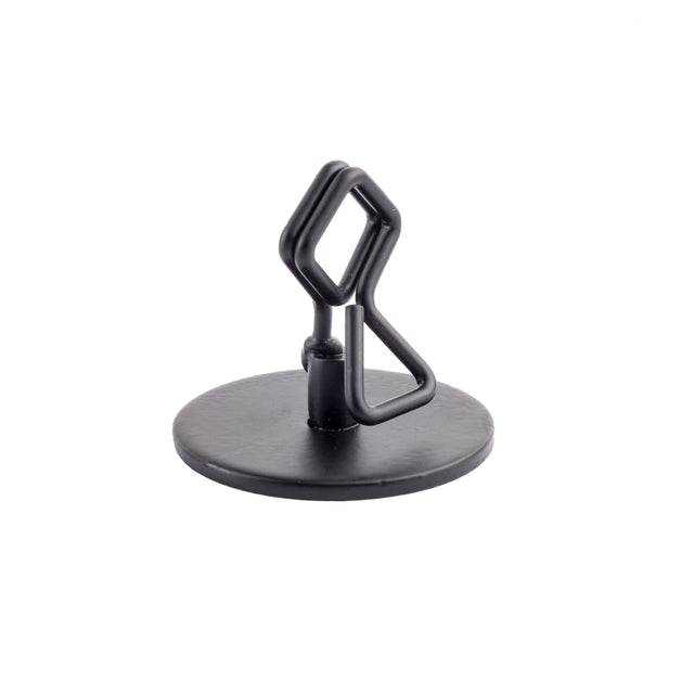 A black, powder coated metal Number/Card Holder Stand with a round base and a central geometric, wire-like structure featuring angular bends and loops. The object is photographed on a white background, with no visible logos or markings.