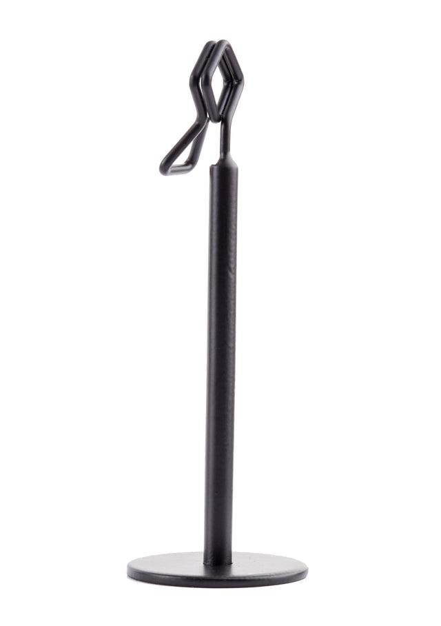 A sleek TableCraft number/card holder stand featuring a black powder coated metal finish, with a round flat base, vertical cylindrical post, and a geometric wire holder at the top for upright display.