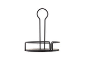 A black powder coated metal paper towel holder with a round base and open circular side for easy roll changes. Its minimal, modern design features a tall central rod with a looped handle. Shown on a plain white background.