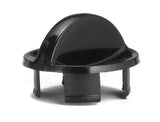 A black plastic automotive fastener, featuring a domed top with a small tab, circular base, and three prongs extending downward for securing into a panel or hole. Made in USA, its smooth and shiny surface has small notches visible at the bottom.