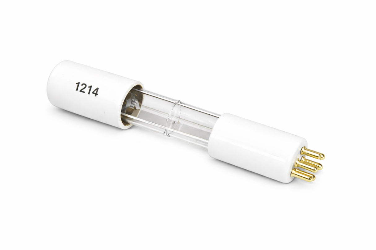 A clear glass UV replacement bulb with white ceramic end caps, each featuring three gold pins. The left end cap is labeled 1214 in black text. Ideal for large machines requiring high intensity light, the lamp lies diagonally on a white background.