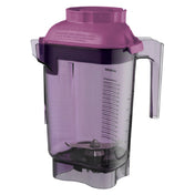 A transparent purple Advance Container jar made from BPA Free Tritan, with a handle, measurement markings, stainless steel blades at the bottom, and a matching purple lid. The empty Vitamix 32 oz jar is photographed on a plain white background.