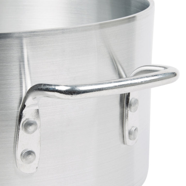 Close-up of a shiny, silver Arkadia Sauce Pot made from 3000 series aluminum, with a riveted metal handle. The brushed texture stands out against the plain white background. Only part of the 10 quart pot and handle are visible.