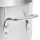 Close-up of a shiny, silver Arkadia Sauce Pot made from 3000 series aluminum, with a riveted metal handle. The brushed texture stands out against the plain white background. Only part of the 10 quart pot and handle are visible.