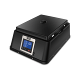 A black, rectangular countertop chocolate melter with a hinged lid and a digital control panel on the front. The panel displays temperature and time settings in blue light, with several buttons below. The appliance sits on a plain white background.