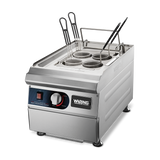 A stainless steel electric Waring rethermalizer pasta cooker with four round mesh baskets, black handles, a temperature control knob, power switch, and indicator light on the front panel, set against a plain white background.