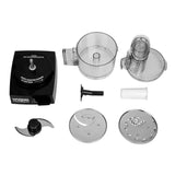 A disassembled Waring Food Processor is shown from above, featuring a black motor base, a 1.7 liter workbowl, lid with feed tube, black S-blade, plastic pusher, stem, and two metal slicing/grating discs arranged neatly.
