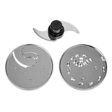 Three shiny metal Waring Food Processor attachments are shown: a wavy-edged chopping blade with a black plastic center, a slicing disc with a curved slot, and a grating disc—all designed for use with the 1.7 liter workbowl against a white background.