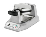 A silver rotating commercial waffle maker, the Waring WBW300X features a black handle, control dial, indicator lights, and the Waring logo. Its metal drip tray and sturdy, modern design make it ideal for frequent use.