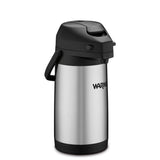 A stainless steel Café Deco Airpot with a black plastic lid, handle, and base. This vacuum insulated airpot features a push-button mechanism, and the brand name Waring is printed on the side. The plain white background highlights the airpot.