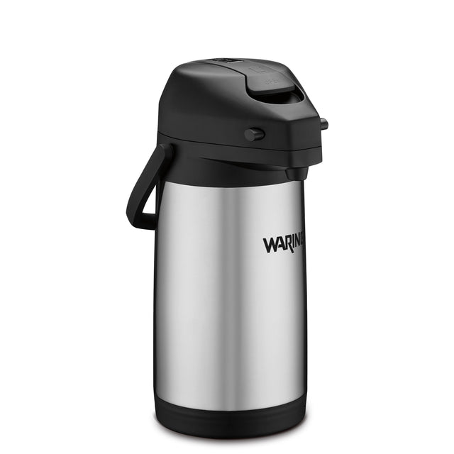 A stainless steel Café Deco Airpot with a black plastic lid, handle, and base. This vacuum insulated airpot features a push-button mechanism, and the brand name Waring is printed on the side. The plain white background highlights the airpot.