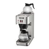 A sleek, modern commercial coffee maker with two glass carafes—one atop a warming plate, the other in the main brewing area. This stainless steel coffee brewer features the Waring logo, two red switches, and indicator lights on its front panel.