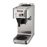A stainless steel commercial coffee machine with a rectangular build, labeled WARING on the front. It features a black dispenser spout, two indicator lights (red and green), “BREW” and “READY” buttons, and a round warming plate at the base.