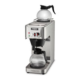 A stainless steel Waring automatic coffee brewer with two glass carafes, one on the warming plate above and one positioned for brewing below. This commercial coffee machine features control buttons, indicator lights, and a sleek, modern design.