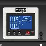 Close-up of a Waring Commercial chocolate melter digital control panel. The blue screen displays PROBE 115, TEMP SET 115°F, and READY with a steaming icon. This sleek countertop unit features stainless steel buttons for precise control.