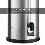 Close-up of a brushed stainless steel Coffee Urn’s lower section, featuring a black spigot, green “READY” indicator light, red power switch, and vertical sight glass. Text overlay reads: INDICATORS Power ON/READY Indicators and Removable Sight Glass Gauge.