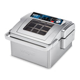 This Waring countertop Vacuum Packaging Machine features a stainless steel body, transparent lid, digital control panel, and multiple displays. Its modern design is complemented by the embossed Waring logo on the front.