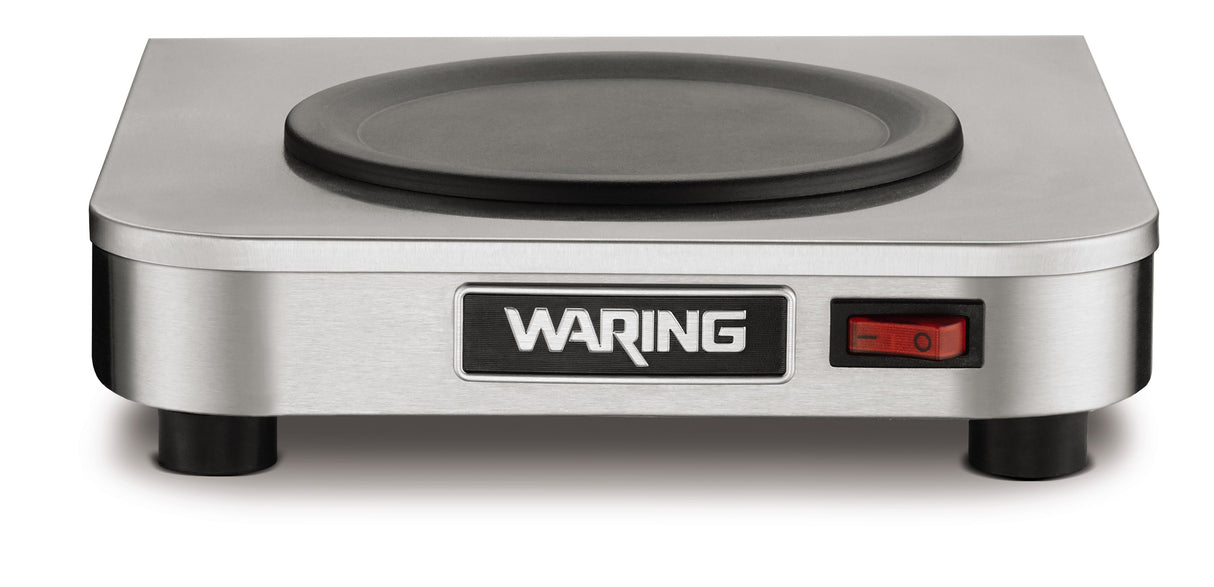 A stainless steel Waring single-burner electric hot plate, ideal as a coffee warmer, is shown from the front. It features a black round heating surface, a red on/off switch to the right, and stands on four black feet.