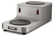 The Café Deco Coffee Warmer features a stainless steel build, two black heating plates in a double burner design, red power switches for upper and lower control, and four sturdy feet. Its compact style fits any space with one plate on top and one in front.
