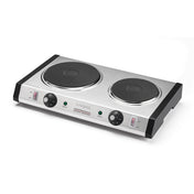 A heavy-duty, silver rectangular commercial burner with two black cast iron heating plates of different sizes, each with its own control knob and indicator lights, black handles on both sides, and labeled “Waring” at the front center.