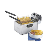 A Waring deep fryer with two baskets filled with waffle fries sits on a counter. Next to it is a white bowl of waffle fries and a small cup of ketchup on a blue cloth napkin. The electric deep fryer’s controls are visible on the right.