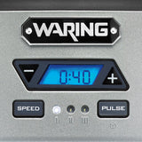 A digital control panel on the Waring WDM120TX Single Spindle Drink Mixer displays 0:40 in blue. It features left and right arrow buttons, SPEED and PULSE buttons below, and three indicator lights with increasing line symbols on a metallic gray background.