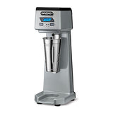 A metallic silver Waring WDM120TX drink mixer with a digital display and control buttons on the top front panel. This single spindle machine features a stainless steel mixing cup and sits on a sturdy rectangular base.