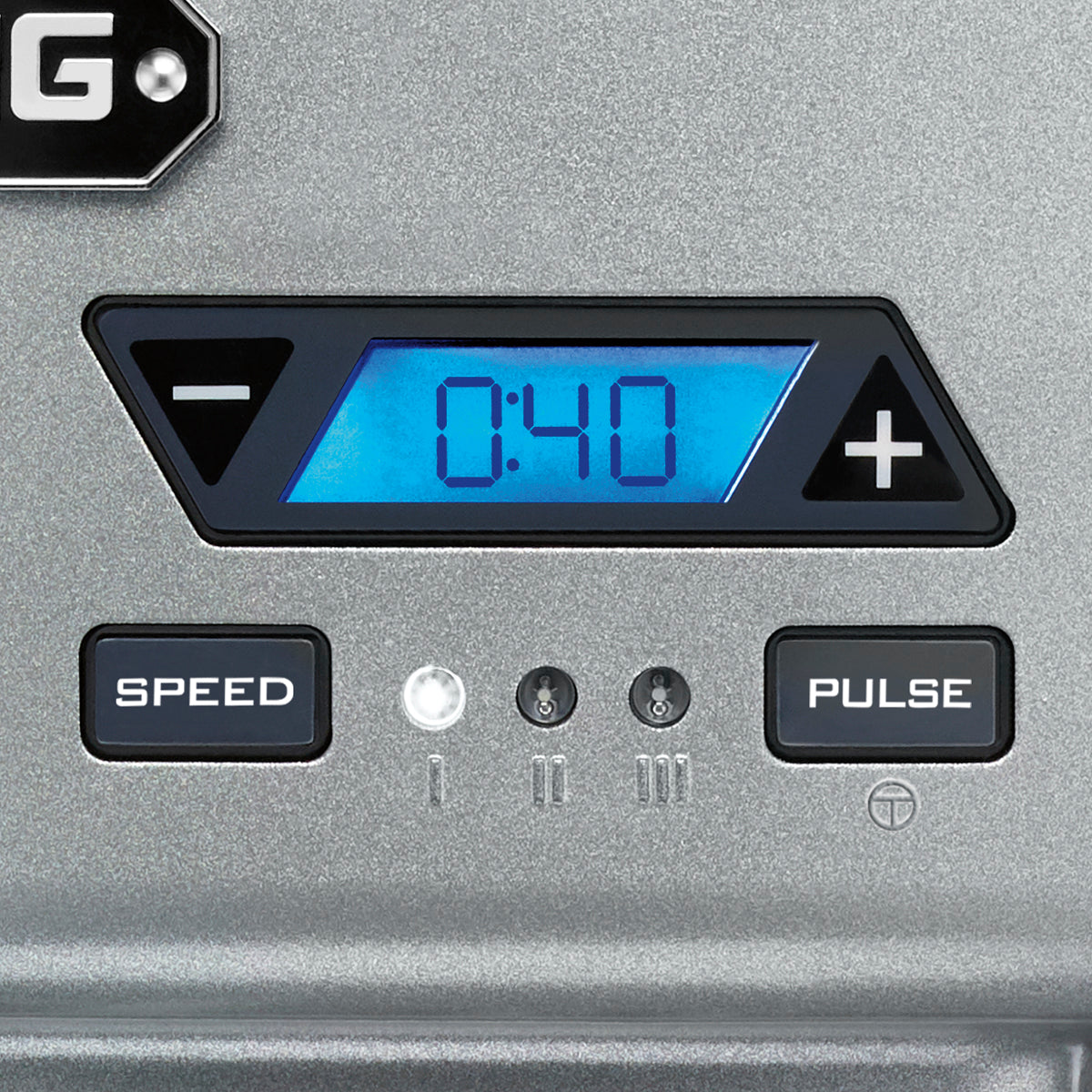 A digital display on a metallic Waring drink mixer shows “0:40” in blue. To the left and right of the display are black arrow buttons. Below, “SPEED” and “PULSE” buttons flank three small indicator lights between them.