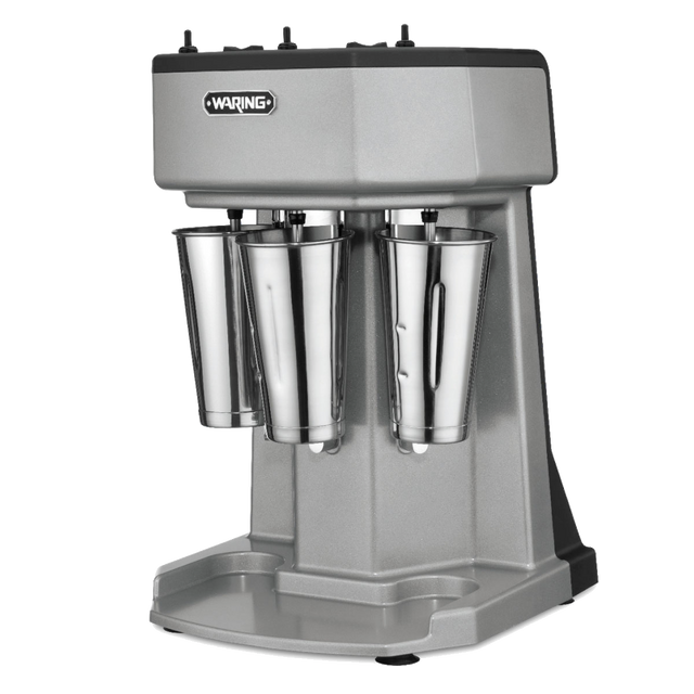 A silver Waring triple spindle Drink Mixer with three metal blending cups, black controls on top, and a sturdy base, set against a plain white background.