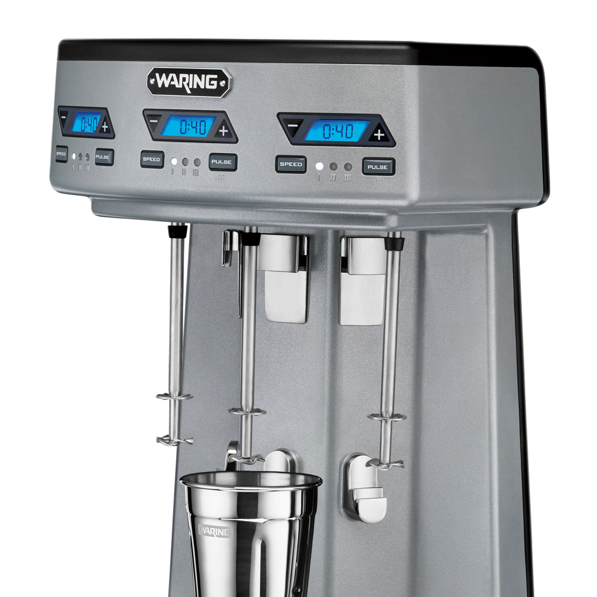 The Waring WDM360TX Drink Mixer features a sleek metallic design with triple spindle action. Each digital blue display shows 0:40, and the three control panels offer speed, pulse, and more. A stainless steel mixing cup sits beneath one spindle.