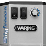 Close-up of a silver Waring appliance labeled “big freeze,” featuring a START/STOP button, MAX PULSE button, round dial numbered 40–100, the Waring logo at center, and equipped with a Solid Agitator like the WDM500 series.