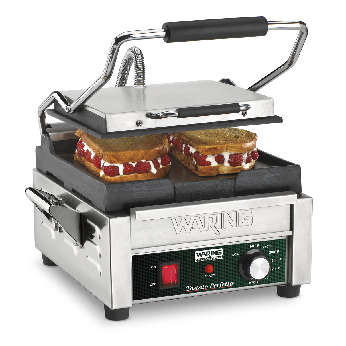 A stainless steel Compact Toasting Grill with a black handle is open, grilling two sandwiches. The sandwiches have golden brown bread and a visible filling of white cream and sliced strawberries. It features adjustable thermostats and displays the brand Waring.