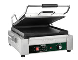 A stainless steel Waring Panini Grill with a black handle and open top grill plate. The front features a programmable timer reading 5:00, a temperature control knob, and on/off switch. The flat lower grill plate is non-stick and ready for use.