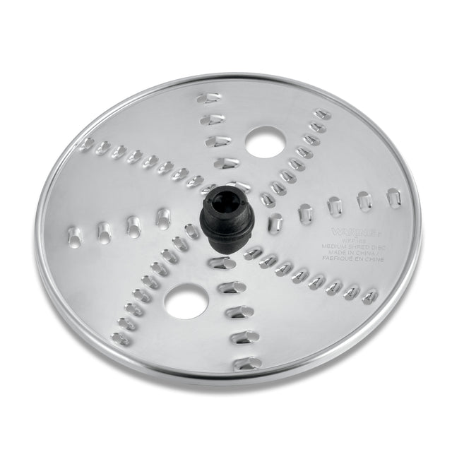 A round, shiny stainless steel Waring reversible shredding disc with a black central plastic hub and sharp, curved grating slots in a spiral pattern. Compatible with the WFP16S food processor, it features engraved text and two circular holes.