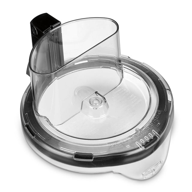 A clear plastic Waring Sealed Bowl Cover for food processors, featuring a built-in feed chute. The round lid has measurement markings, a locking mechanism, and fits WFP16S models for easy ingredient addition while processing.