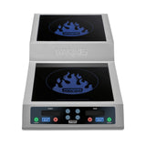 A stainless steel countertop induction range with digital controls. This double hob features blue flame logos and Waring Commercial text above each burner, plus clearly labeled Front and Rear control buttons and displays. The Waring logo is embossed on the front.