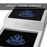 Close-up of a Waring Commercial Double Hob countertop appliance with two large, black ceramic glass cooking surfaces, each featuring a blue flame graphic and product logo. The 11x11 Schott® surfaces are known for durability.