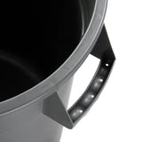 Close-up of a heavy duty gray plastic trash can showing part of its open top, side, and sturdy handle with grip holes. The 20 gallon container appears empty, showcasing its smooth, durable surface and rounded edges.