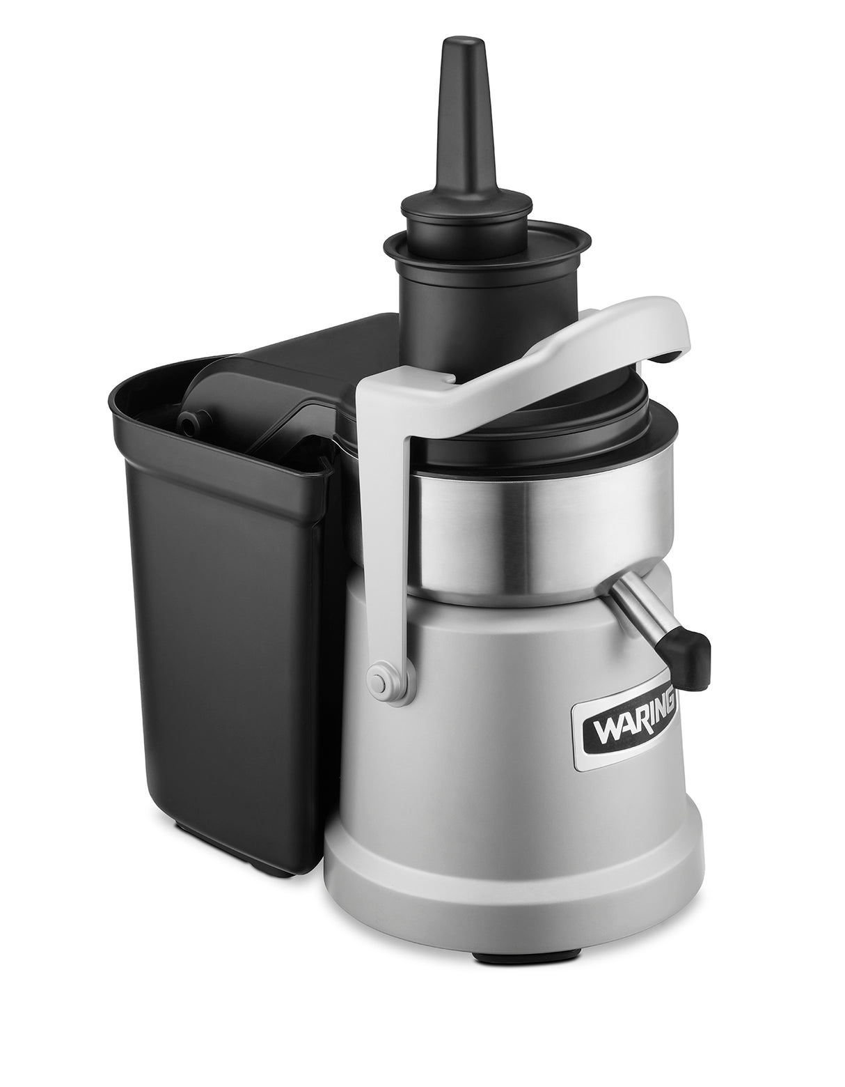 A heavy duty silver and black electric juice extractor with a Waring label features a cylindrical main body, black chute and pusher, side pulp container with continuous pulp ejection, and a silver spout for dispensing fresh juice.