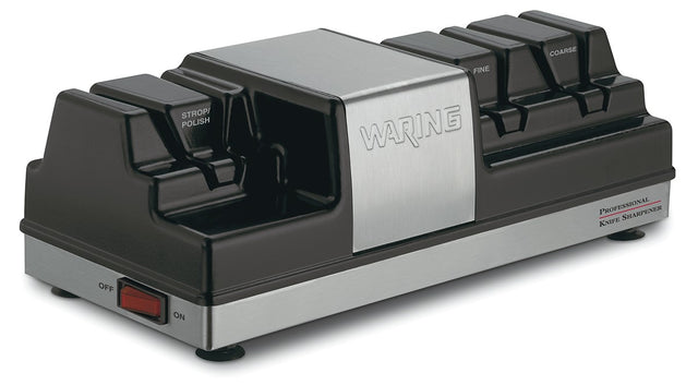 A black and silver electric Knife Sharpener with labeled slots for Strop/Polish, Fine, and Coarse grinding wheels, a Waring logo on the metal front, red power switch at the base, and Professional Knife Sharpener text on the right side.