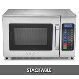 A stainless steel Waring 1800 watt commercial microwave oven with a digital keypad and display. The keypad has numbers, colored buttons, and a 2:30 timer. Below the microwave is a gray banner with STACKABLE in bold white letters.