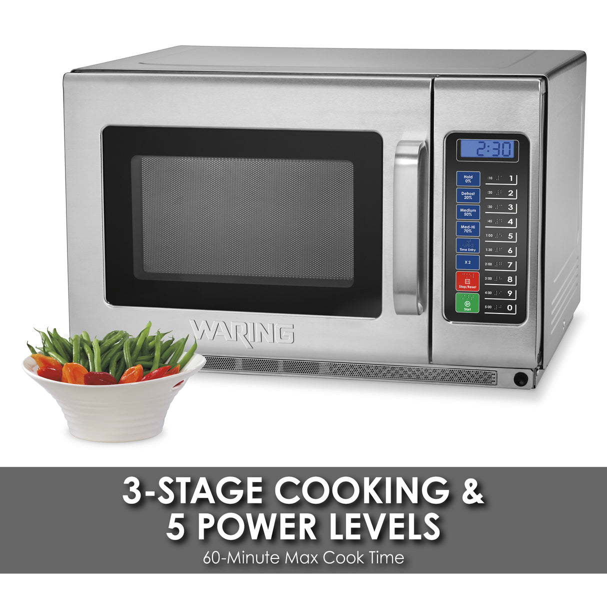 A Waring heavy duty microwave oven with a digital keypad and display reading 2:30 sits behind a bowl of mixed vegetables. Text below reads: 3-stage cooking & 5 power levels. 60-minute max cook time. Stainless steel, 1800 watt microwave.