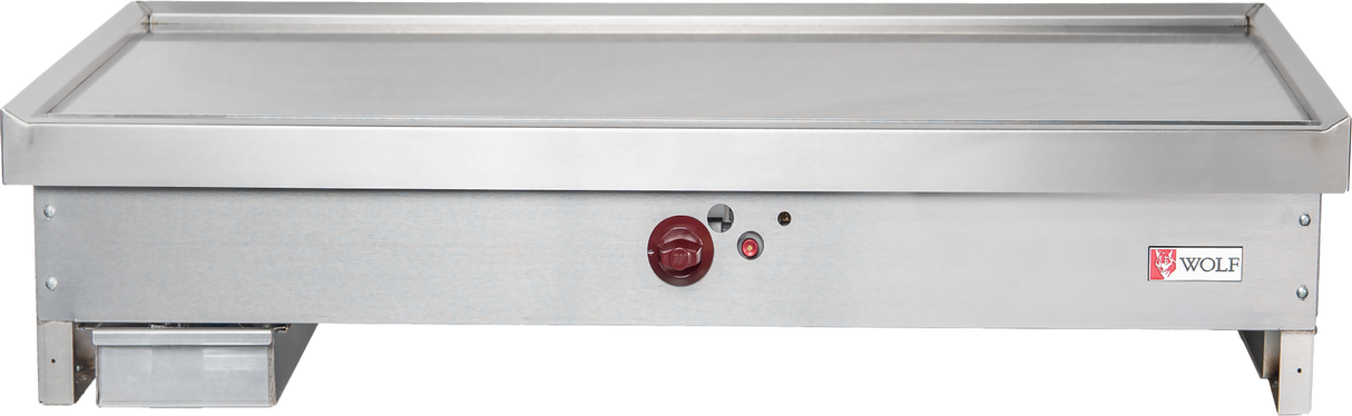 A stainless steel Wolf TYG48C_LP teppanyaki griddle with a flat 48-inch cooking surface, red temperature control knob, indicator lights, left grease tray, and Wolf logo on the right. The commercial griddle is clean and set against a white background.