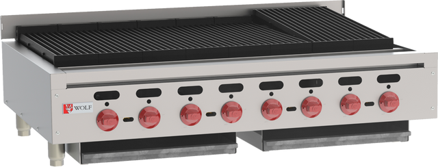 A commercial gas charbroiler with six red control knobs, two black drip trays beneath, and a Wolf logo on the front panel. The cooking surface has wide, black grill grates, with an upper right section slightly elevated for high-efficiency grilling.