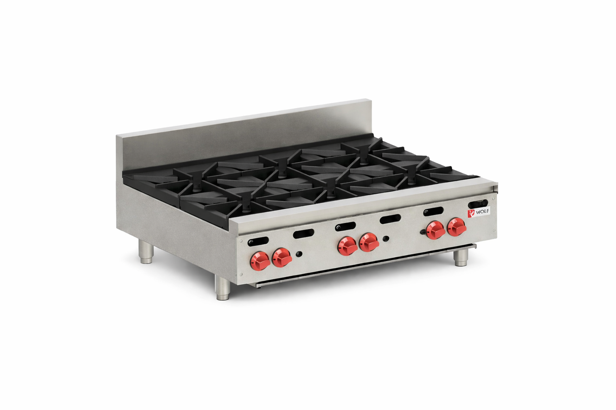 A commercial 36-inch hotplate with four large black burner grates, red control knobs, and a silver backsplash. The appliance features sturdy legs and a compact, rectangular shape ideal for heavy-duty kitchen use.